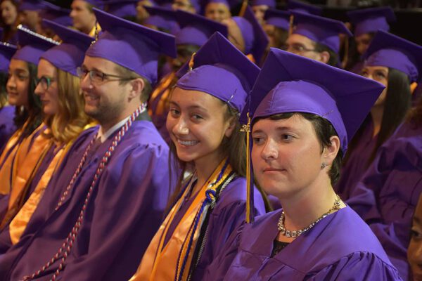 Close-up shot of four students at the Community College of Denver graduation ceremony.